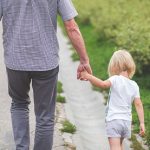 Dad and Child Walking From the Back