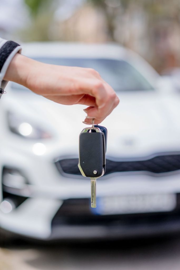 person holding a car key
