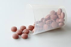 Nonaspirin Painkiller Peptic Ulcers_page 1_brown pills falling out of container