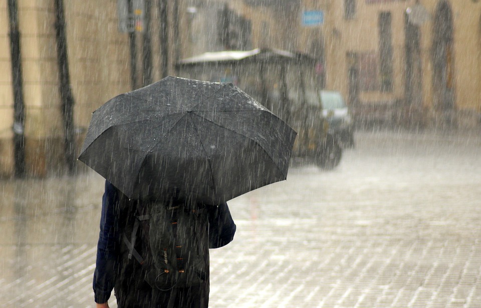 Rain on Man With a Black  Umbrella