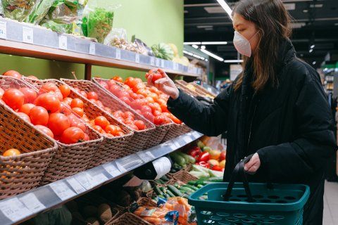 Woman-in-face-mask-shopping-in-supermarket-3987223