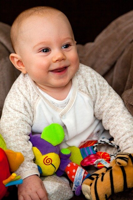 Baby Sitting Up With Toys Around Him-22086_640
