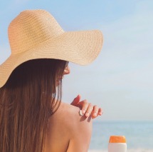 Most sunscreens provide poor protection or contain questionable ingredients, environmental group says Sunbather-Putting Sunscreen on Her Shoulder Wearing Big Tan Sun Hat