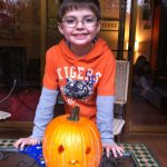 Pumpkin Carved Boy in Orange Shirt and a Big Smile
