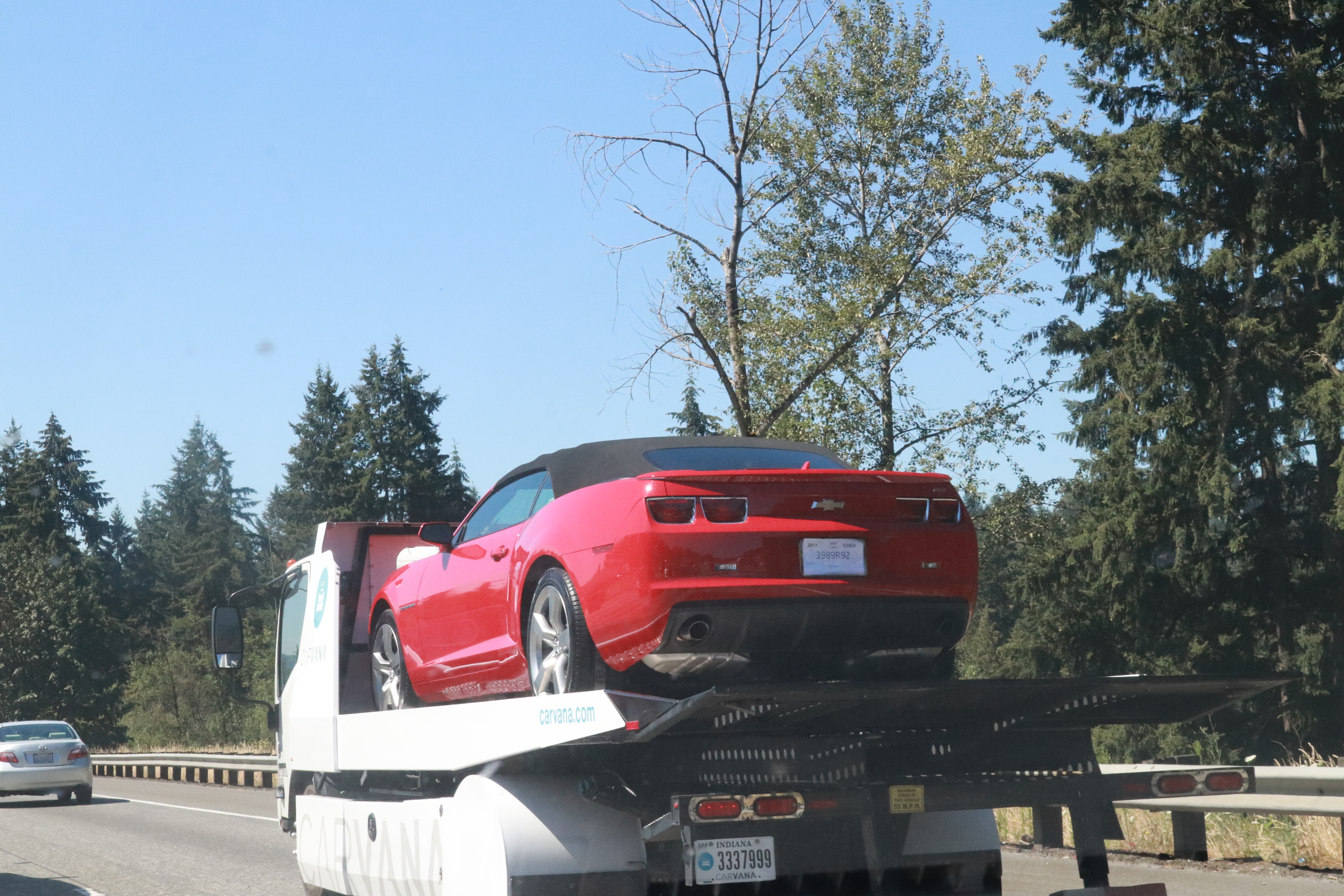 Car Red Being Hauled on Truck