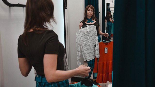 Shopping Woman Holding Up Clothes in a Mirror-4988807_640