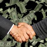 Consumer groups ask Congress to oppose 100%-plus APR bank loans Money handshake-3100563