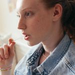 close up photo of a woman in denim top