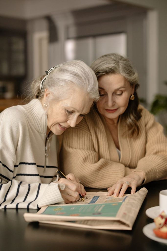 woman writing on a newspaper