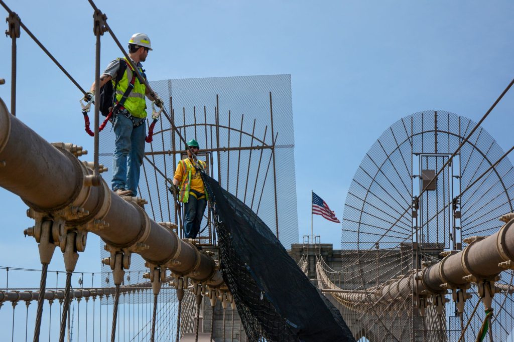 workers on brooklyn bridge with safety gear