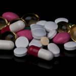 Big Pharma is favored over patients in Trump administration’s drug pricing deals, consumer group says assorted pills and tablets piled on a black surface