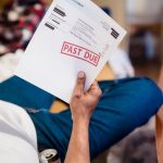 How to reduce your utility bills man holding past due billing statement