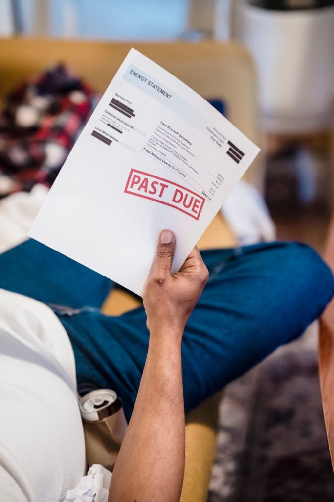 man holding past due billing statement