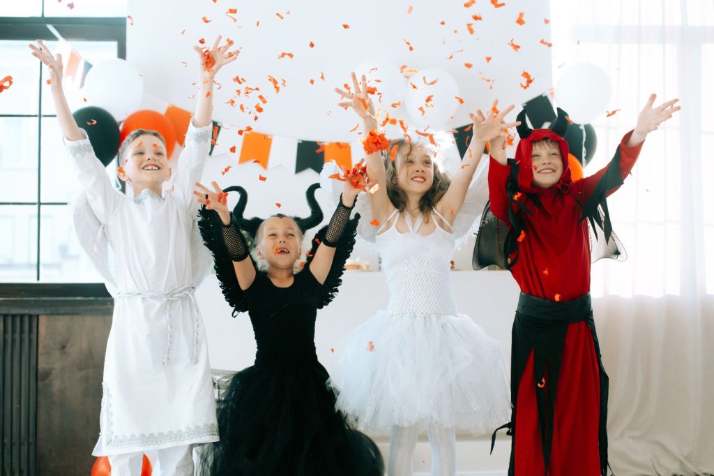 children in halloween costumes having fun celebrating the party