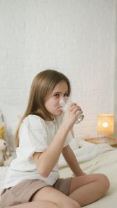 photo of a girl drinking a glass of water